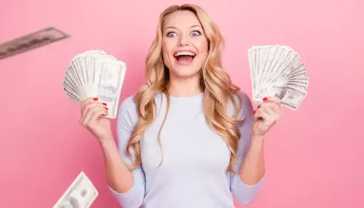 girl with money in hands pink background